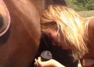 Blonde is blowing a horse cock
